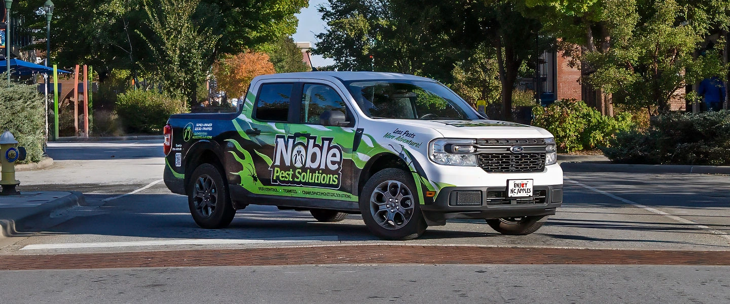 Noble Pest Solutions service truck parked on a street